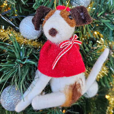 Felt dog ornament with a red collar hanging on a Christmas tree.