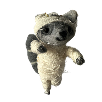 Felted Racoon Halloween decoration wrapped in bandages on a plain background