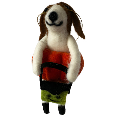 Small felted dog resembling a Jack-O-Lantern holding a green candy bag on a white background