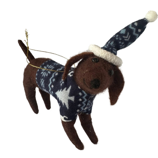Felted Dog wearinga blue Christmas sweater with white patterns on a light gray background