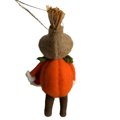 Small decorative figure with a pumpkin body and straw hat on a plain background