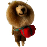 Small brown felted Lion with a red Christmas gift on a white background