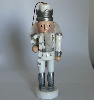 Wooden nutcracker figurine on a white background
